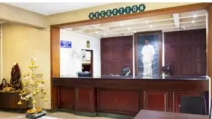 Hotel Thaai reception area interior opposite Coimbatore Railway Station showing front desk and traditional hospitality ambiance in Coimbatore