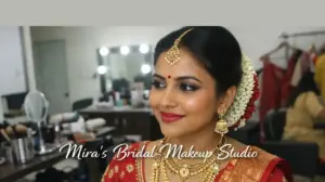 Indian bride with professional bridal makeup by Mira’s Bridal Makeup Studio in Coimbatore wearing traditional wedding saree and jewelry