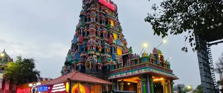 Perur Arulmigu Pateeswaraswamy Temple gopuram illuminated at dusk in Coimbatore, Tamil Nadu, showcasing traditional Dravidian temple architecture