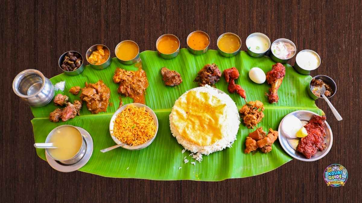 South Indian banana leaf meal with rice, biryani, sambar, rasam, payasam, curries, papad, and side dishes served on a fresh banana leaf – Coimbatore style