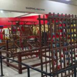 Wooden warping machine with colourful thread spools in the Hall of Textile at Regional Science Centre, Coimbatore
